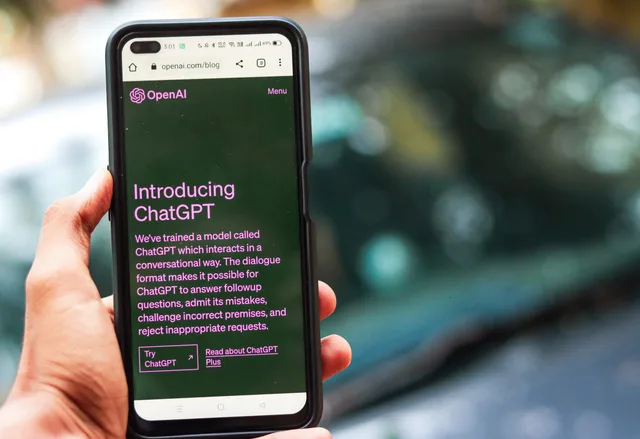 Close-up of a smartphone showing ChatGPT details on the OpenAI website, held by a person. Checking whether a user-interface bot is appropriate